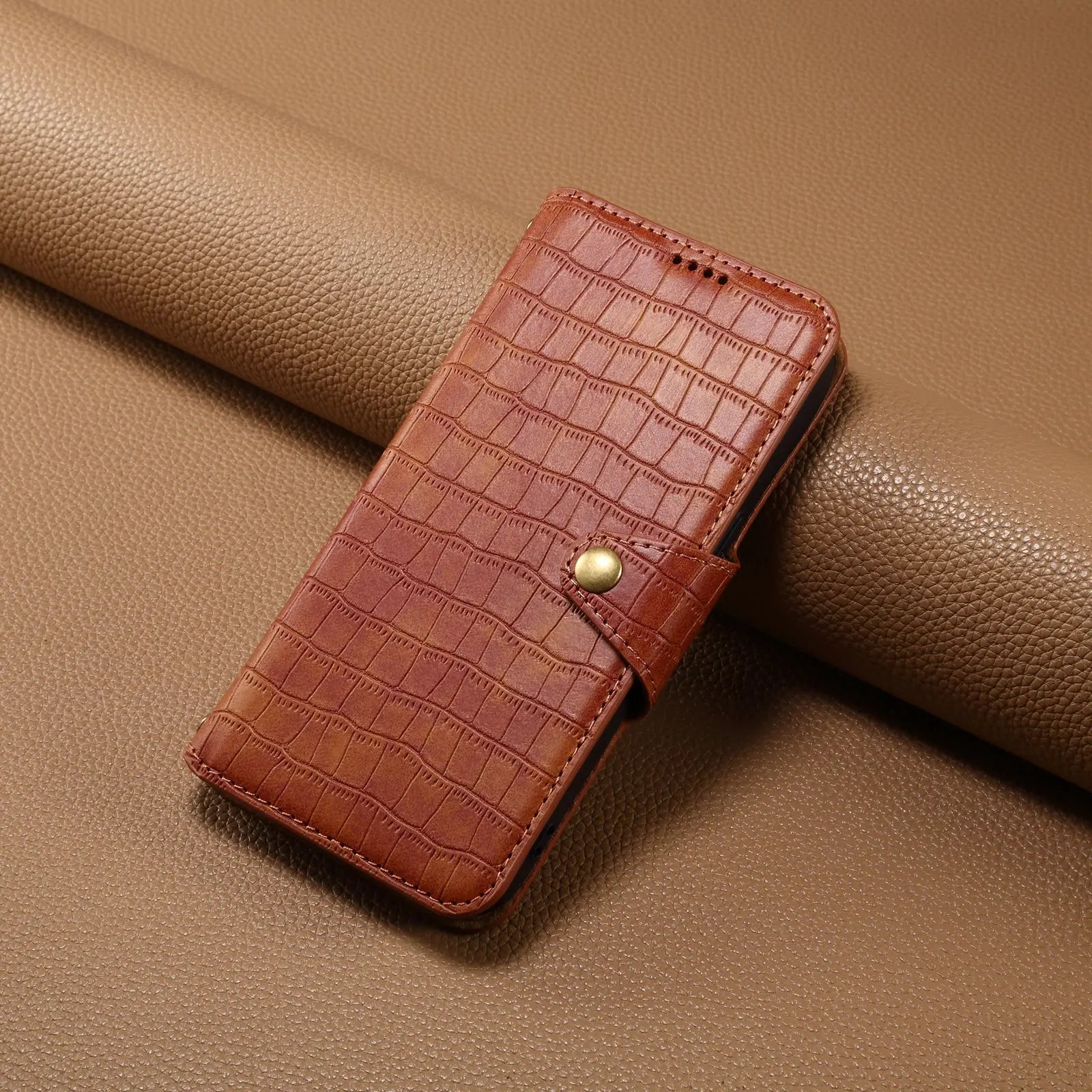 Brown leather iPhone flip case with card holder and strap by PADUCASE, featuring a sleek design and secure closure.