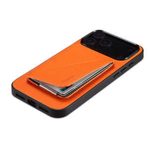 Orange leather MagSafe iPhone case with hidden card slot by PADUCASE, showing the protective cover with card holder feature.