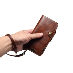 PADUCASE leather iPhone case with card holder, strap, and flip folio design in brown, offering protective and functional phone cover.