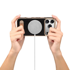 Black leather iPhone case with foldable stand and MagSafe compatibility by PADUCASE, showing the front view with stand extended.