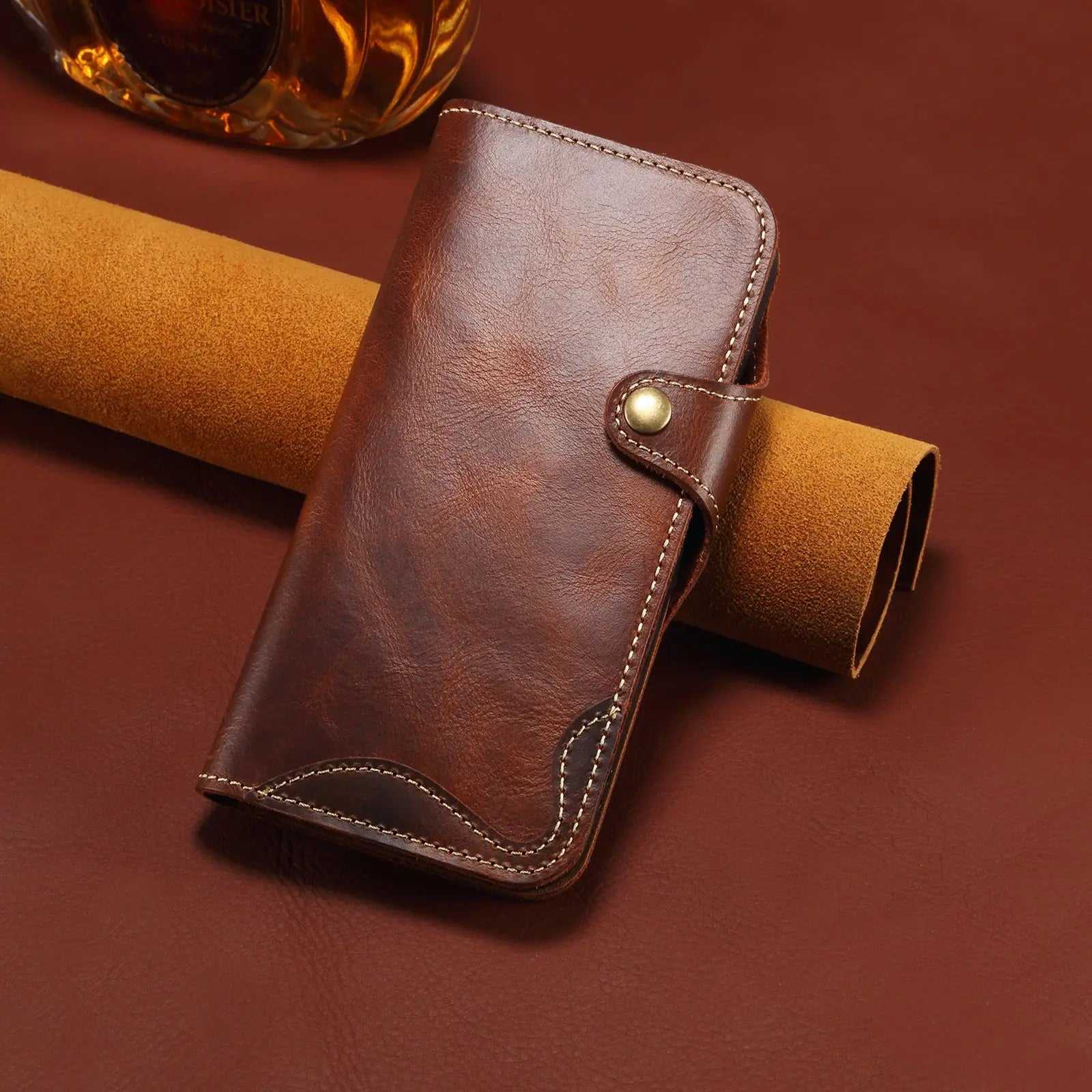 Brown leather iPhone case with card holder and strap, flip folio design by PADUCASE, showing front view with card slots.